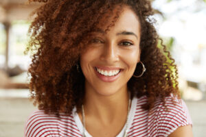 woman smiling confidently with new stunning smile, cosmetic dentistry 