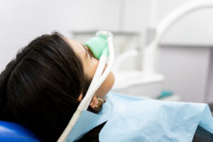 young woman undergoing sedation dentistry to treat anxiety about dental treatment